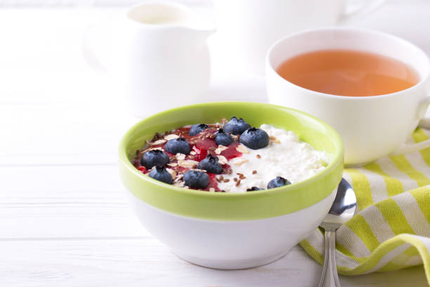 istock Oatmeal with blueberries, jam and yogurt with tea 652815596