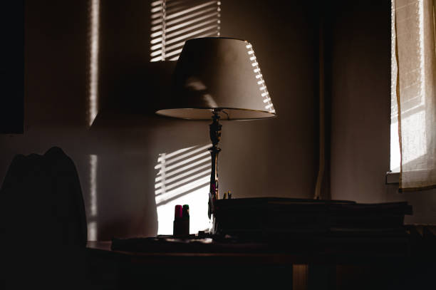 istock Sun rays falling on the desk with books 652815888