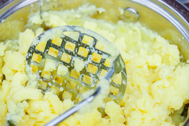 pan of mashed potatoes pan of mashed potatoes just made with masher mash food state stock pictures, royalty-free photos & images