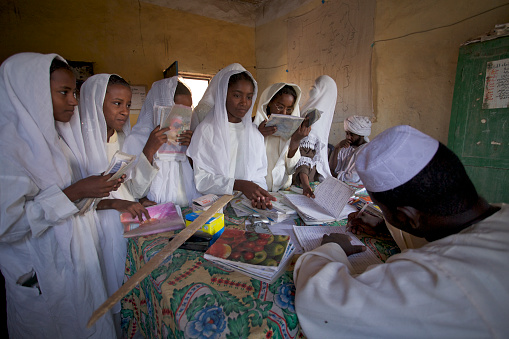 Checking homework for English teacher. The village of El Arr. Region IV katarkaty Nile, Sudan. 1, December 2007