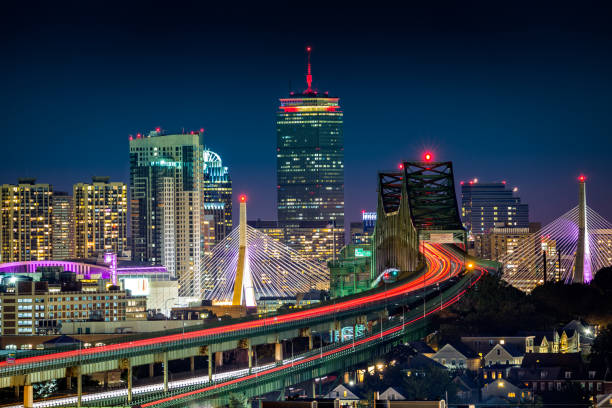 Rush hour traffic on Tobin bridge Rush hour traffic on Tobin bridge (aka Mystic River bride) heading towards Zakim bridge and Boston skyline by night railway bridge photos stock pictures, royalty-free photos & images