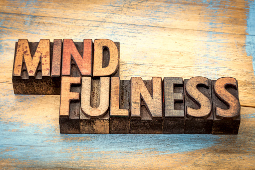 mindfulness word abstract  or banner - awareness concept - text in vintage letterpress wood type stained by color inks