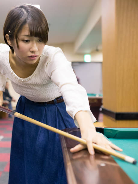 istock Japanese Young woman playing billiards 652826320