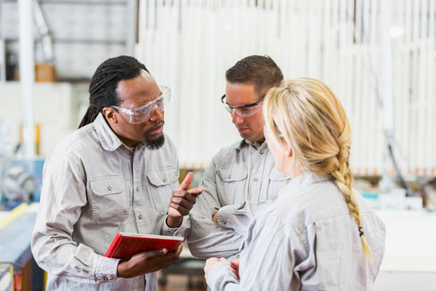 istock Multi-ethnic workers in factory having meeting 652835816