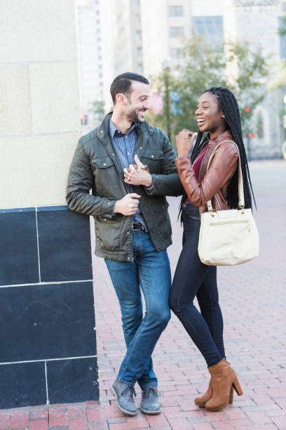 istock Young interracial couple walking in city 652836868