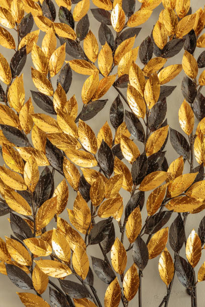istock Close up Gold and black artificial leaf on wall 652842500