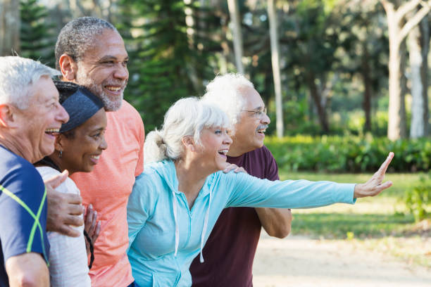 istock Group of five multi-ethnic seniors standing in park 652842590