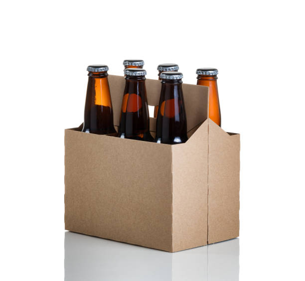 Six pack of glass bottled beer in generic brown  carrier Angled view of a six pack of glass bottled beer in generic brown cardboard carrier isolated on white with reflection six pack stock pictures, royalty-free photos & images