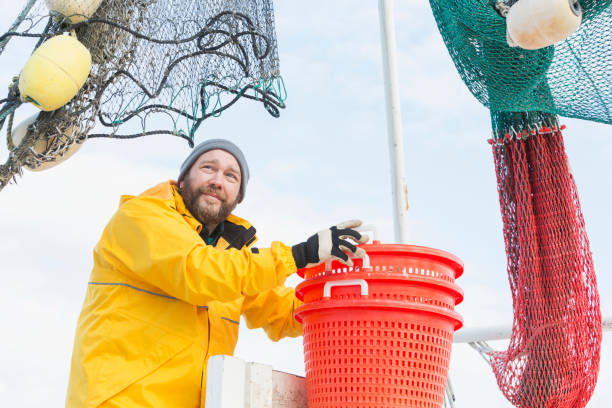 istock Man working on commercial shrimp boat stacking baskets 652843692