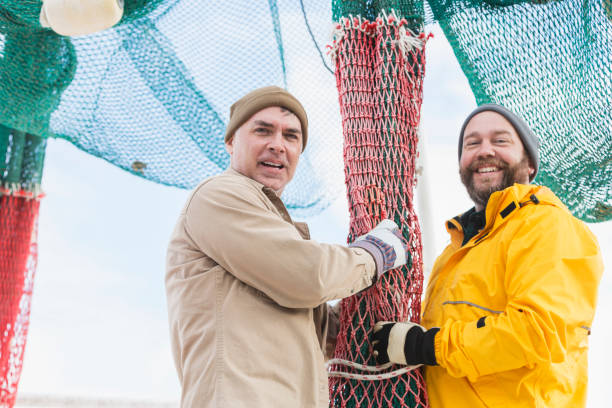 istock Men working on commercial fishing boat preparing nets 652843784