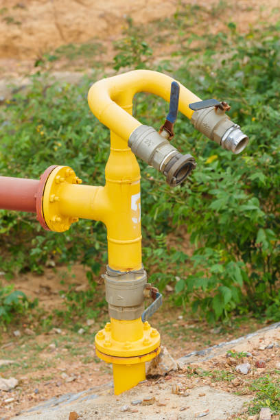 istock yellow valve water pump and red pipe line on nature background 652846312