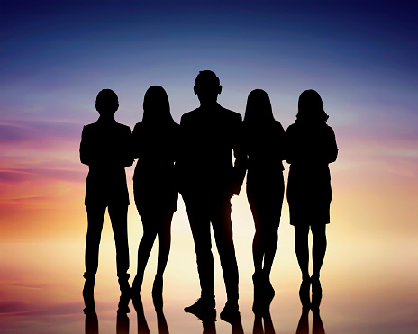 Silhouettes of group business people against colorful background