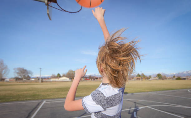istock Boy with braces playing with basketball 652858042