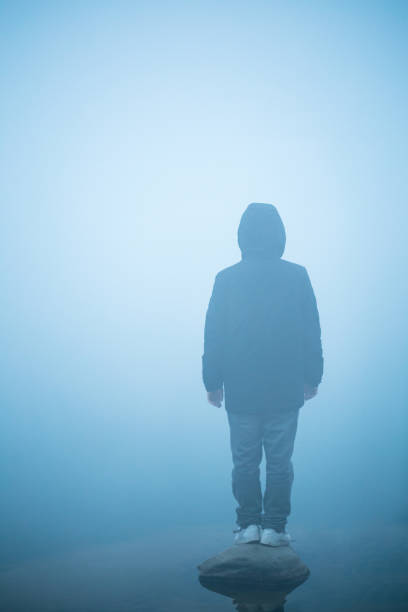 istock young man standing in the mist 652869040