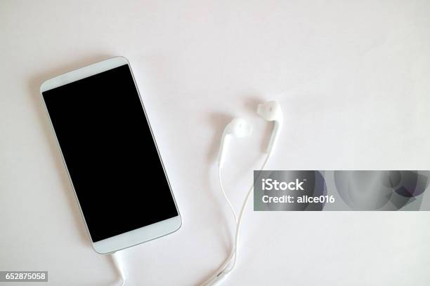 Technology Music Gadget And Object Concept Close Up Of White Smartphone And Earphones Stock Photo - Download Image Now
