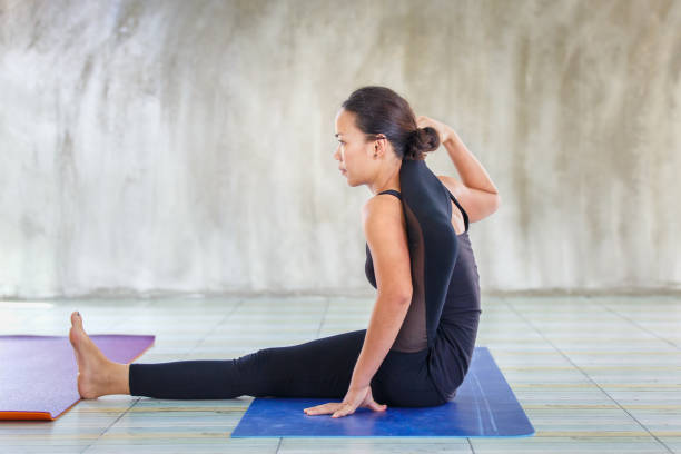 istock Asian trainee strong woman practicing difficult yoga pose in a concrete background, Sport healthy concept 652875278
