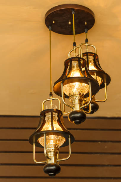 istock Yellow lamps with glass structure on ceiling in ballroom 652885738