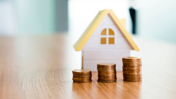 istock House and stacks of coins on table 652897206