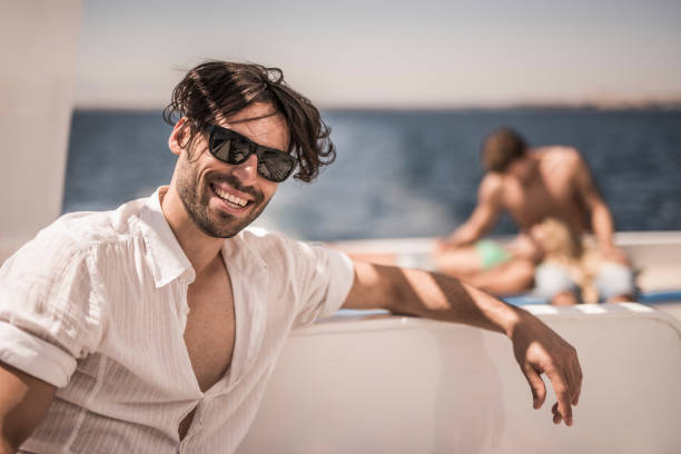 istock Young happy man enjoying in summer day on a boat. 652904526