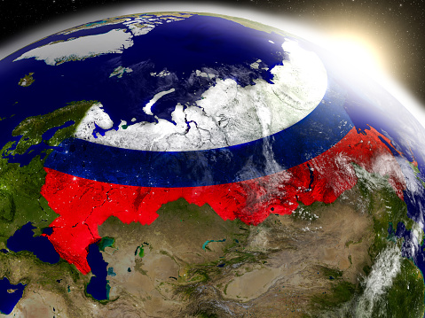 Russia with embedded flag on planet surface during sunrise. 3D illustration with highly detailed realistic planet surface and visible city lights. 3D model of planet created and rendered in Cheetah3D software, 9 Mar 2017. Some layers of planet surface use textures furnished by NASA, Blue Marble collection: http://visibleearth.nasa.gov/view_cat.php?categoryID=1484
