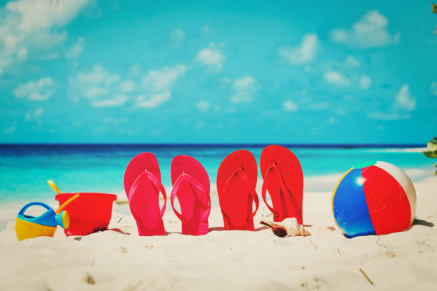 istock slippers, toys and diving mask at beach 652915656