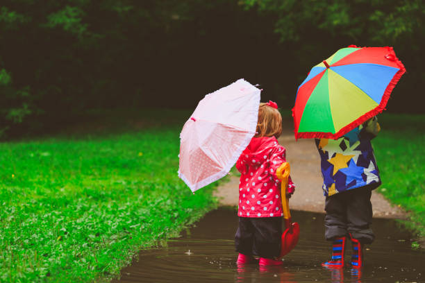 istock little boy and girl with umbrellas playing in spring 652917964