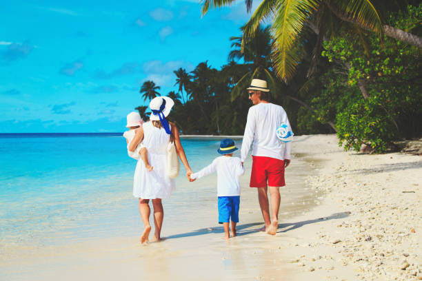 istock family with two kids walk on beach 652918388