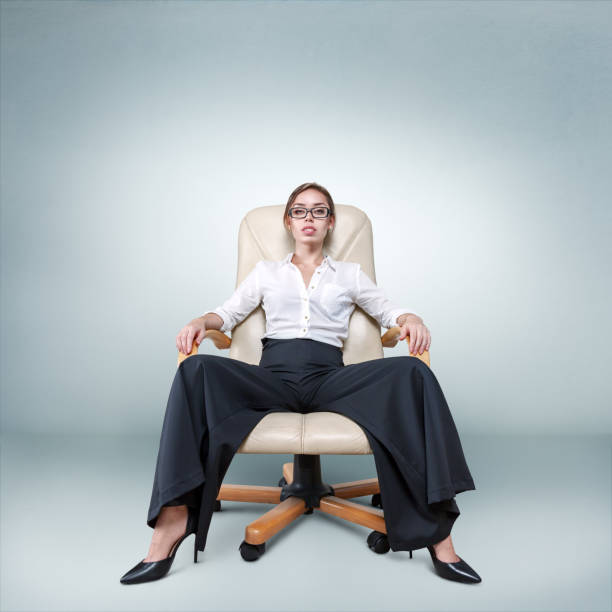 istock Young woman sitting in armchair 652928688