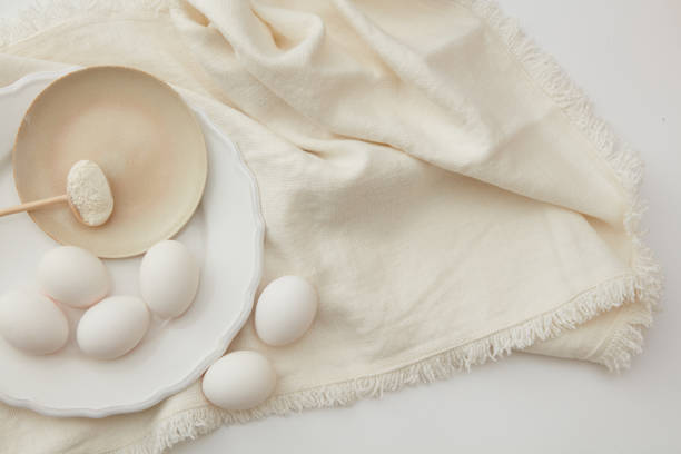 istock Raw eggs and spoon of flour 652932504