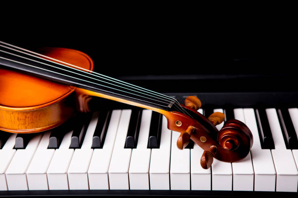 istock Violin on the piano on a black background 652933088