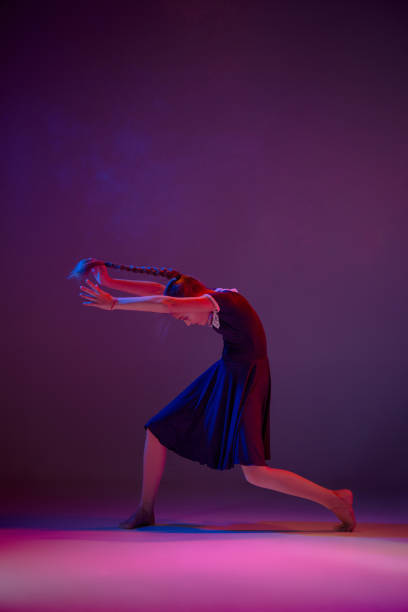 The teen modern ballet dancer The female teen modern ballet dancer on blue and pink studio background dance troupe stock pictures, royalty-free photos & images