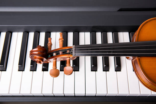 istock Violin on the piano on a black background 652938868