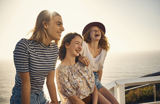 Shot of young teenage friends spending time together outdoors