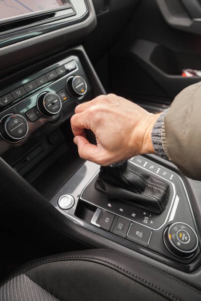 istock Driver hand holds gear lever of crossover 652946930