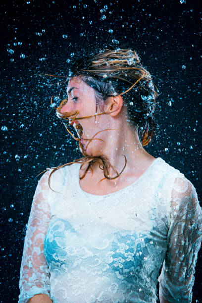 istock The young girl standing under running water 652948052