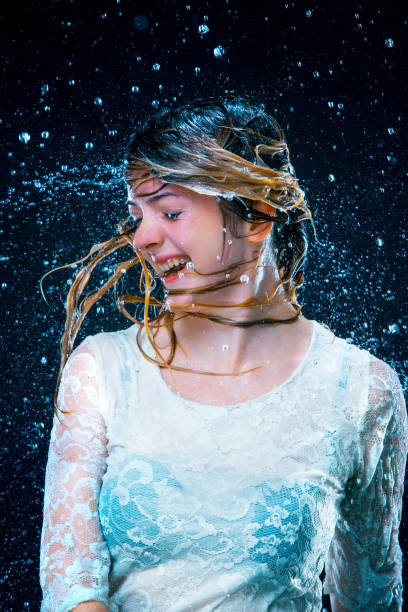 Portrait of young woman with wet face.