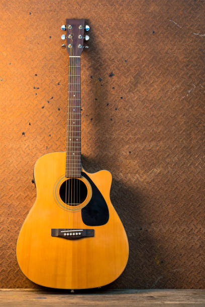 istock Acoustic guitar on old steel  background 652948904