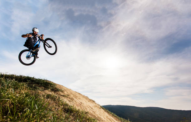 istock Below view of extreme cyclist jumping  against the sky. 652953192