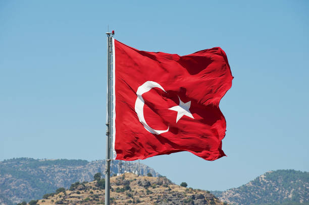 istock Turkish National flag at the flagpole waves over a hill in Bodrum, Turkey. 652954144