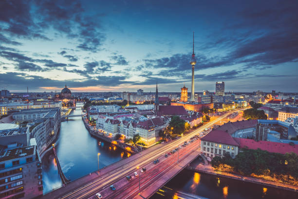 Berlin skyline panorama in twilight during blue hour, Germany Aerial view of Berlin skyline with dramatic clouds in twilight during blue hour at dusk, Germany east berlin photos stock pictures, royalty-free photos & images
