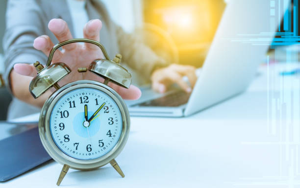 istock Business people write something about meeting subject on laptop computer hand holding the clock ,business content and business background. 652976404