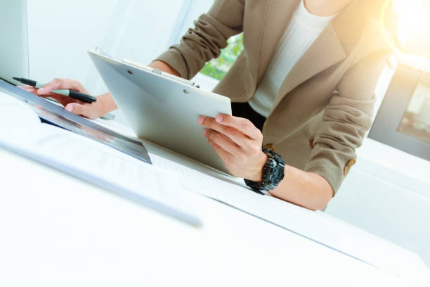 istock business documents on office table and graph business diagram and business people working in the background,business content,business background. 652976532