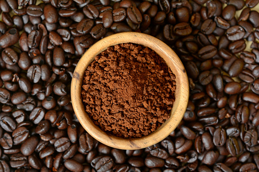 Coffee ground Powder in Wood Bowl.