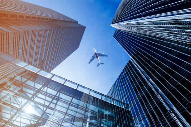 istock Airplane flying over business skyscrapers. 652980392