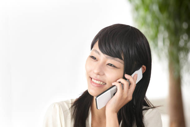 istock Young Japanese woman talking on cell phone 652980394
