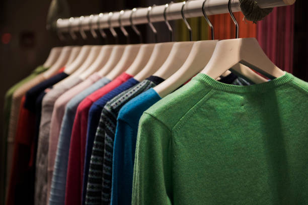 Color sweaters on a rack in a boutique store