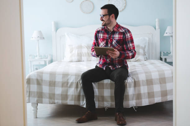istock Handsome man using tablet and shopping online at home 652990046