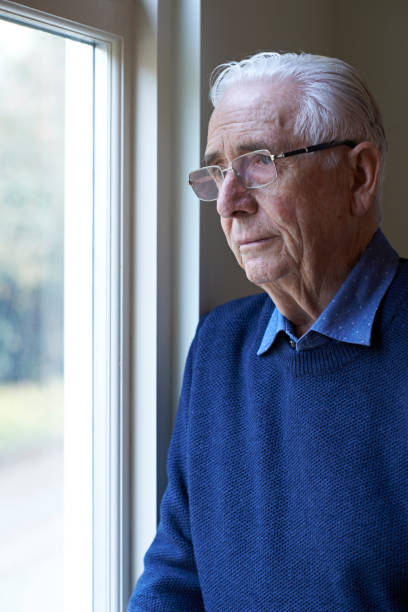 istock Senior Man Suffering From Depression Looking Out Of Window 653000626