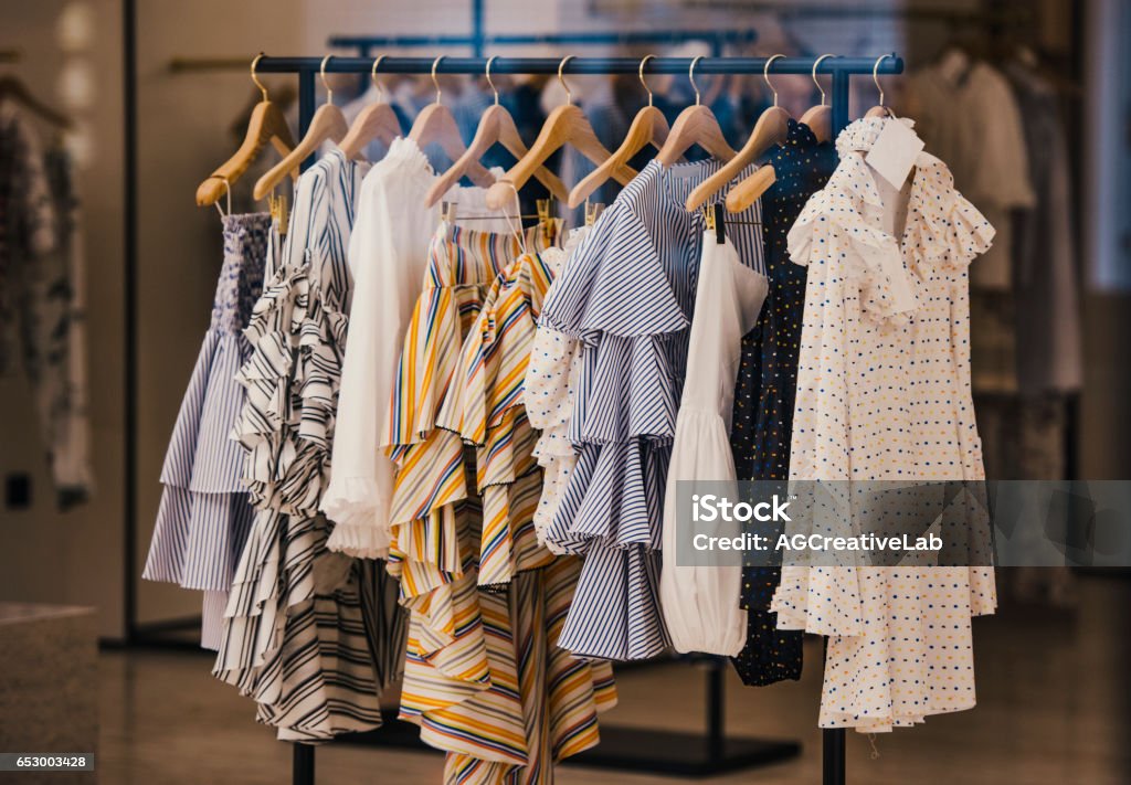 Fashionable clothes in a boutique store in London. Clothing Stock Photo