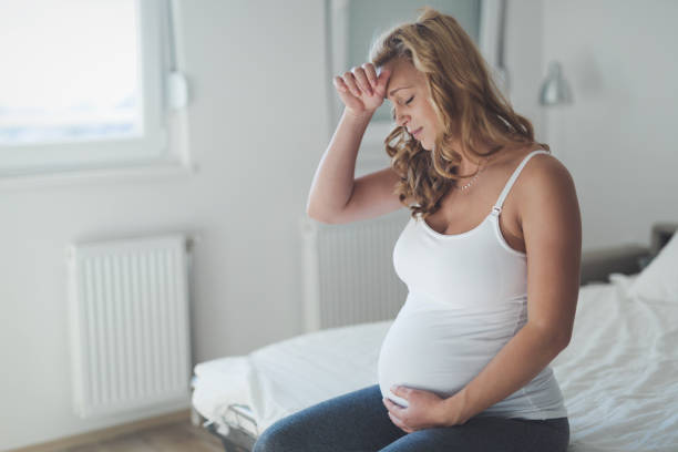 istock Pregnant woman suffering with headache and nausea 653003570